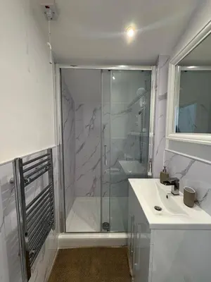 a bathroom with a shower and a sink at Cinema room apartment 2 in Basildon