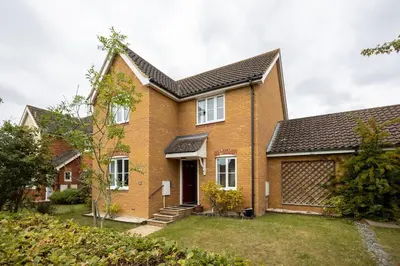 a brick house with a black roof at Brook - Sizewell - Contractor Accommodation in Saxmundham