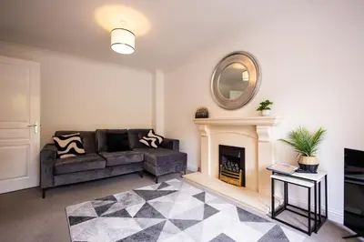 a living room with a couch and a fireplace at Brook - Sizewell - Contractor Accommodation in Saxmundham