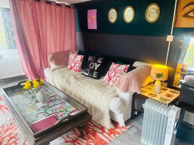 a living room with a couch and a table at Lookout cabin farm stay firepit Hertford in Hertford