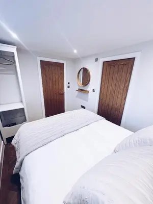 two beds in a white room with two windows at Little Dunton Lodges 2 in Brentwood