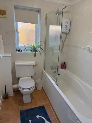 a bathroom with a toilet and a tub and a window at The Wright Place To stay in East Harling