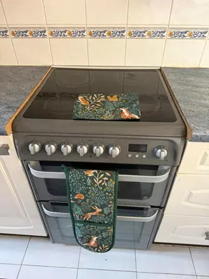 a stove with two towels sitting on top of it at The Wright Place To stay in East Harling