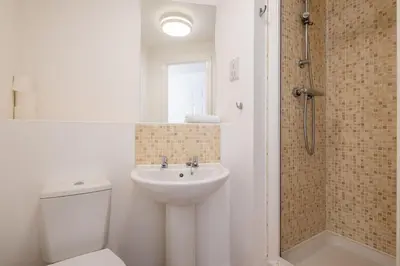 a bathroom with a toilet and a sink and a shower at Spacious 2BR I 2BA I Sleeps 4 I Near Science Park in Milton