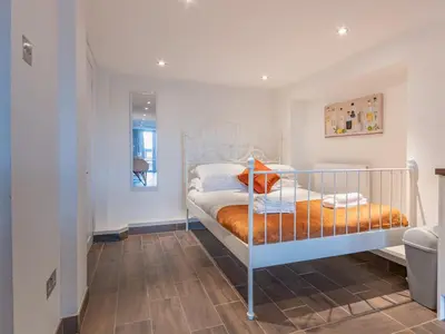 a bedroom with a bunk bed with an orange blanket at Pass the Keys Cosy Studio in Basildon Sleeps up to 4 in Basildon