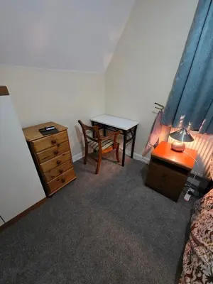 a bedroom with a desk and a table and a bed at Charming Colchester Room with Garden Views in Colchester