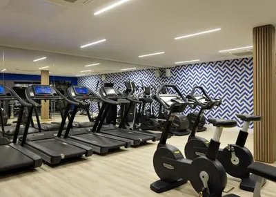 a gym with treadmills and elliptical machines at For Students Only - Student Castle Cambridge in Cambridge
