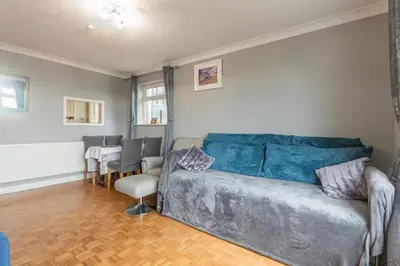 a living room with a couch and a table and chairs at Pass the Keys Seaside Escape 2-Bedroom Flat EastBeach sleeps 4 in Southend-on-Sea
