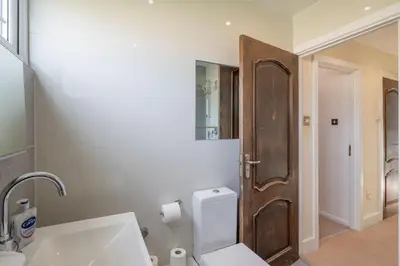 a bathroom with a sink and a toilet and a mirror at 4 BR I 2 BA I Sleeps 8 I Spacious I Modern I Wi-Fi I in Cambridge