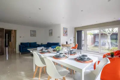 a living room with a white table and chairs at 4 BR I 2 BA I Sleeps 8 I Spacious I Modern I Wi-Fi I in Cambridge
