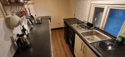 a kitchen with a sink and a counter top at The Walnut Nook in Abbess Roding