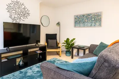 a living room with a couch and a flat screen tv at The Little Nest in Colchester in Colchester