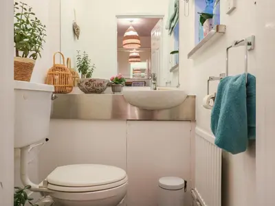 a small bathroom with a toilet and a sink at Berkley Cottage in Colchester
