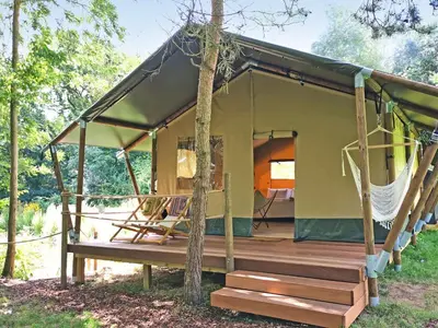 a green house with a porch and a deck at The Apple Bobber - Ukc7130 in Cratfield