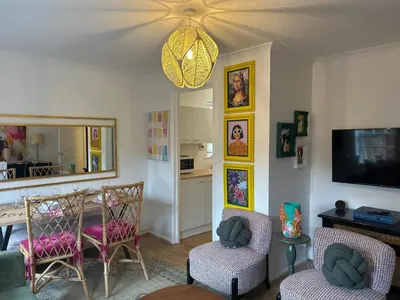 a living room with chairs and a table and a television at Stylish One Bedroom Apartment in Central Potton in Potton