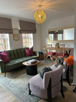 a living room with a green couch and chairs at Stylish One Bedroom Apartment in Central Potton in Potton