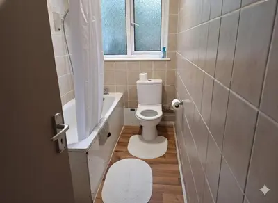 a small bathroom with a toilet and a window at Modern 4BR Cambridge House with Parking for 9 guests in Cambridge