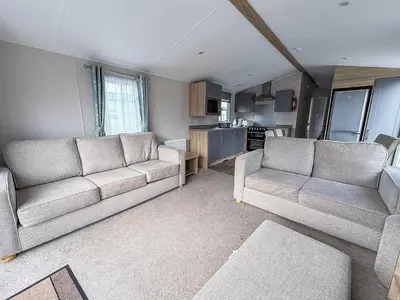 a living room with two couches and a kitchen at Spacious 8 Berth Caravan With Decking At Naze Marine In Essex Ref 17012Rd in Walton-on-the-Naze