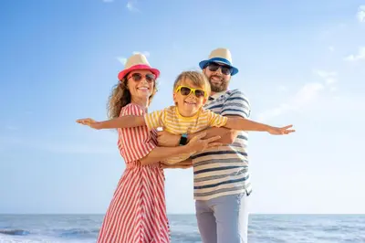 a group of three people standing on the beach at Spacious 8 Berth Caravan With Decking At Naze Marine In Essex Ref 17012Rd in Walton-on-the-Naze