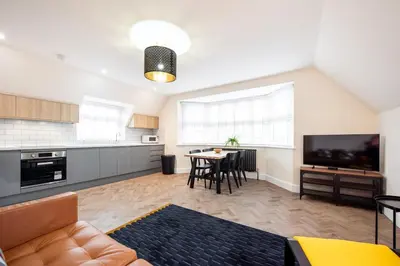 a living room with a kitchen and a dining room at 5 The Royal Serviced Apartments Harwich, Private Parking, Fast Wifi in Parkeston
