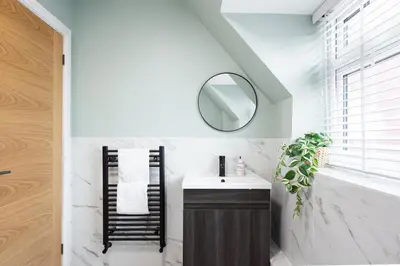 a bathroom with a sink and a mirror at 5 The Royal Serviced Apartments Harwich, Private Parking, Fast Wifi in Parkeston