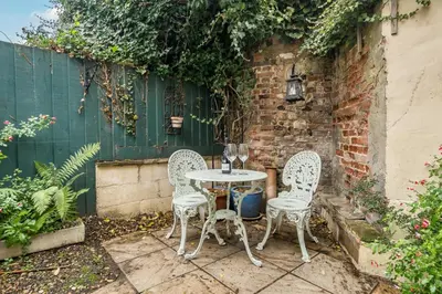 two chairs and a table in a garden at Bridewell Lane, Bury St Edmunds, Suffolk in Bury Saint Edmunds