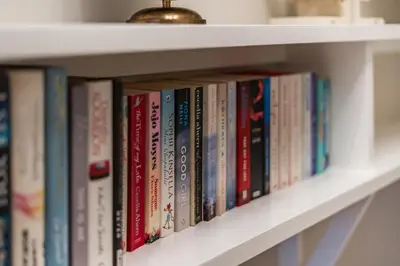 a row of books on a book shelf at Bridewell Lane, Bury St Edmunds, Suffolk in Bury Saint Edmunds
