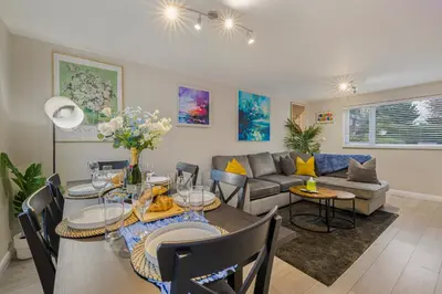 a living room with a table and a couch at Modern Comfort, Free Parking, Netflix & Disney plus in every Bedroom and Living Room in Shephall