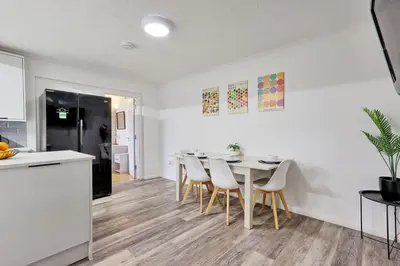 a kitchen and dining room with a table and chairs at Surehaven Stays 6 Bedroom House Great for Teams in Colchester