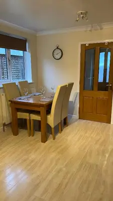 a dining room with a wooden table and chairs at The cottage in Bury Saint Edmunds