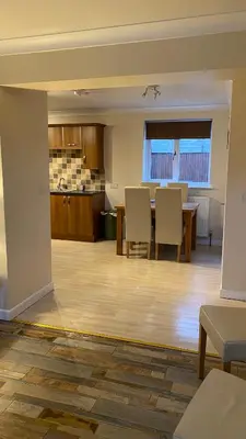 an empty living room with a table and chairs at The cottage in Bury Saint Edmunds