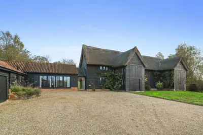 an exterior view of a house with a driveway at Scotland Hall Barn, Stoke by Nayland, Suffolk in Stoke by Nayland