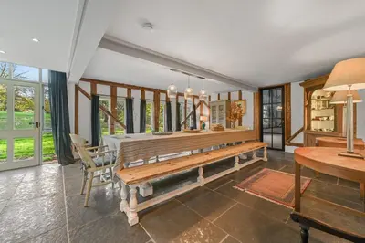 a dining room with a bench and a table at Scotland Hall Barn, Stoke by Nayland, Suffolk in Stoke by Nayland