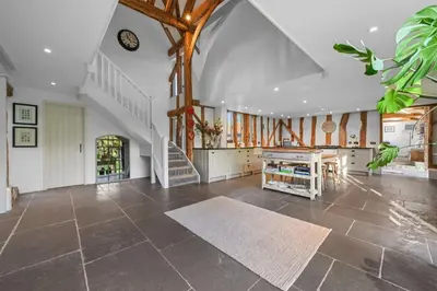 a large living room with a staircase in a house at Scotland Hall Barn, Stoke by Nayland, Suffolk in Stoke by Nayland