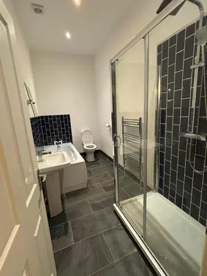 a bathroom with a shower and a sink and a toilet at Brandon House in Brandon