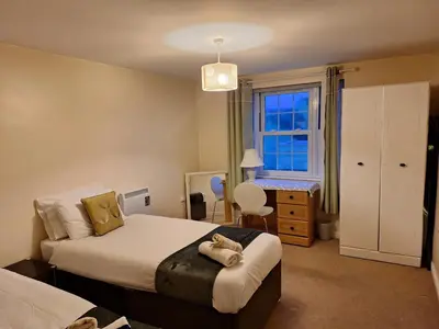 a bedroom with two beds and a window at 2 Bed - Sleeps 4 - Free Parking in Ely