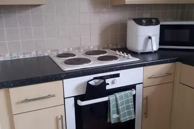 a kitchen with a stove and a counter top at 2 Bed - Sleeps 4 - Free Parking in Ely