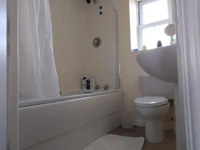 a bathroom with a tub and a toilet and a sink at 2 Bed - Sleeps 4 - Free Parking in Ely