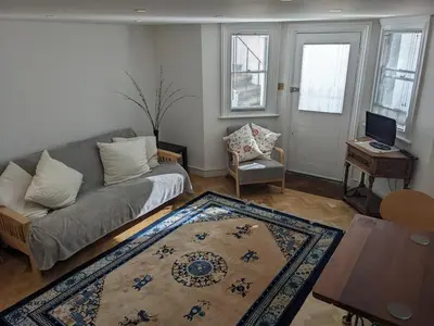 a living room with a couch and a table at Beautiful apartment in central Cambridge in Cambridge