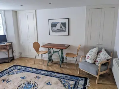 a living room with a table and a chair at Beautiful apartment in central Cambridge in Cambridge