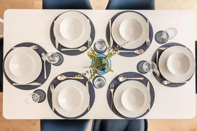 a table with black and white plates and glasses at 4 Bed, 3 Bath Townhouse in Colchester - Business, Contractor and Leisure - Singles or Superkings - Disc0unts in Lexden