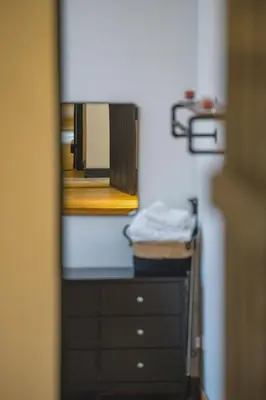 a bathroom with a mirror and a dresser in a room at An elegant countryside hideaway with four indulgent ensuite bedrooms in Fressingfield