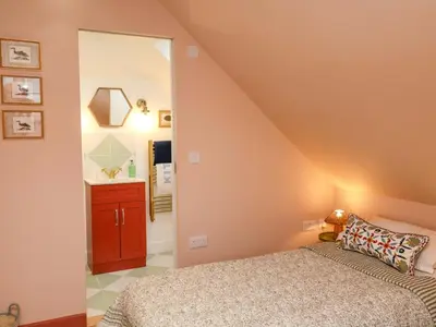 a bedroom with a bed and a mirror at 52 Lee Road in Aldeburgh