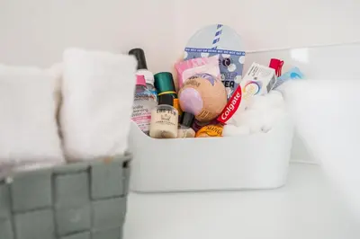 a basket filled with toiletries in a bathroom at The Secret Cottage, Aldeburgh in Aldeburgh