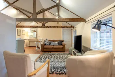 a living room with a couch and a table at 1 Bed in Scole oc-a34355 in Scole