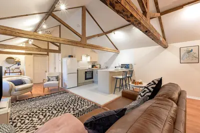 a living room with a couch and a kitchen at 1 Bed in Scole oc-a34355 in Scole