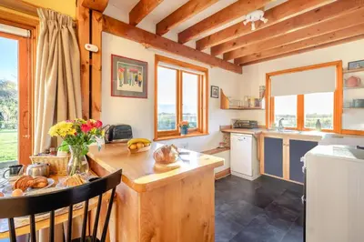 a kitchen with a wooden counter top and a table at 1 Bed in Orford oc-m34121 in Orford