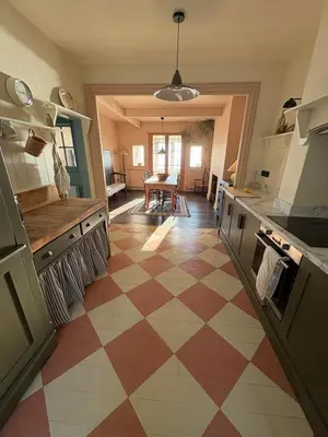 a kitchen with a checkered floor in the middle at Sunray House - Sea View, Beach Front Holiday Home in Felixstowe