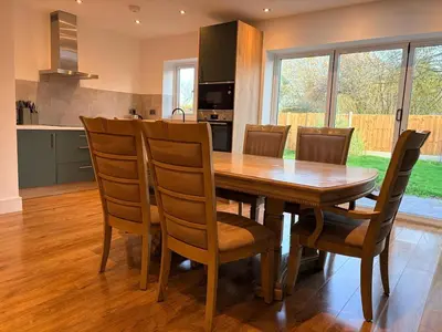 a kitchen and dining room with a wooden table and chairs at Green Rig