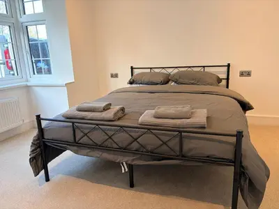 a large bed in a room with towels on it at Green Rig